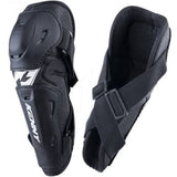Black Kenny motorcycle or motocross shin guard shown from two angles: one showing the outer protective shell with white KENNY branding, and the other showing the inner padded compartment with adjustable straps.